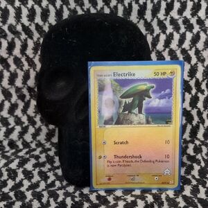 Electrike Pokémon Card with Black Skull Stand